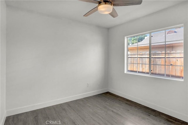 empty room featuring ceiling fan and hardwood / wood-style floors