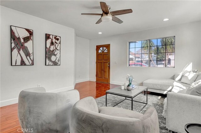 living room with ceiling fan and hardwood / wood-style flooring