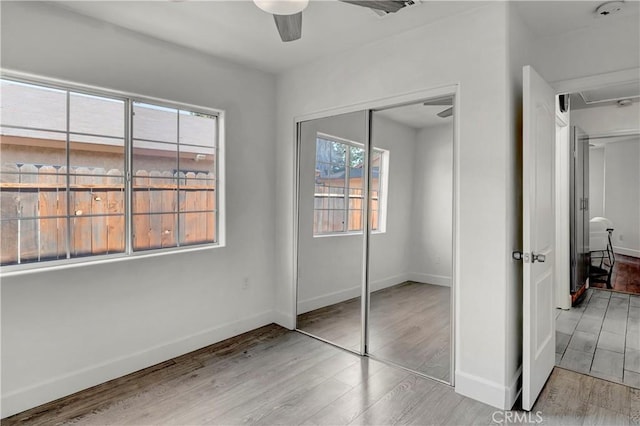 bedroom with ceiling fan, a closet, and light wood-type flooring