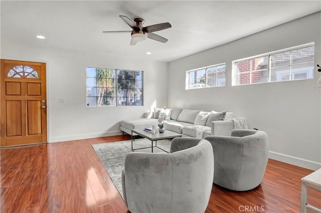 living room featuring ceiling fan and hardwood / wood-style flooring