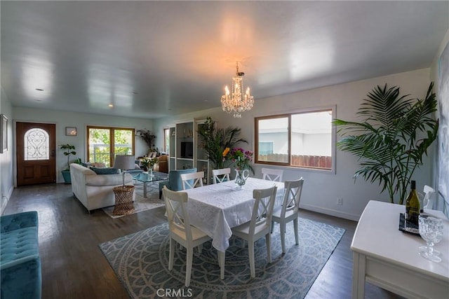 dining space with hardwood / wood-style flooring and a chandelier