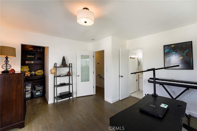 exercise room with dark hardwood / wood-style flooring