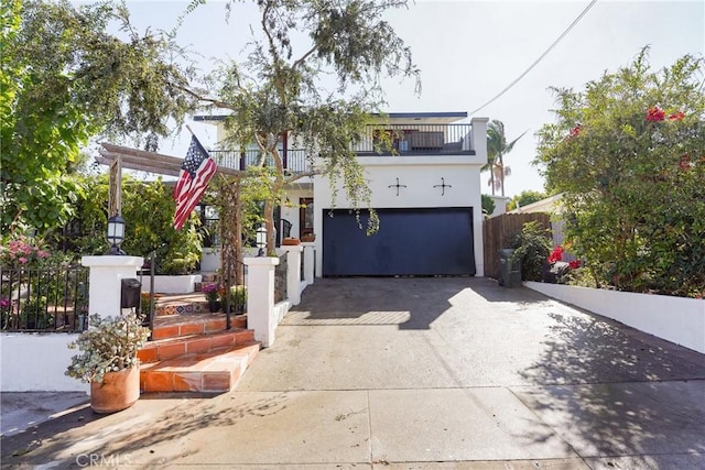 view of front of home with a balcony and a garage