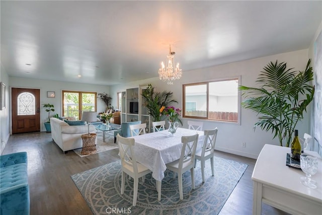 dining area with a chandelier and wood-type flooring