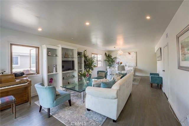 living room featuring wood-type flooring and a notable chandelier