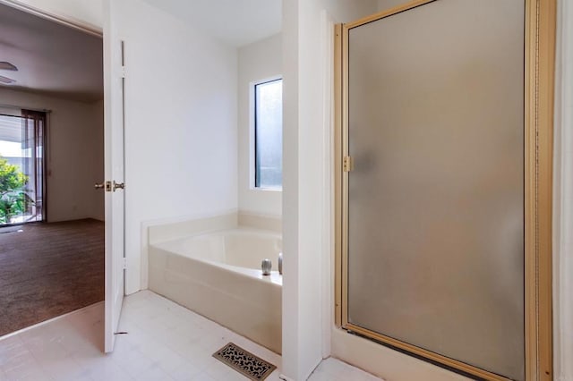 bathroom featuring separate shower and tub and plenty of natural light