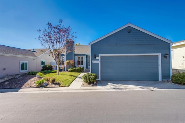 ranch-style house featuring a front lawn and a garage