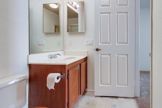 bathroom featuring toilet and vanity