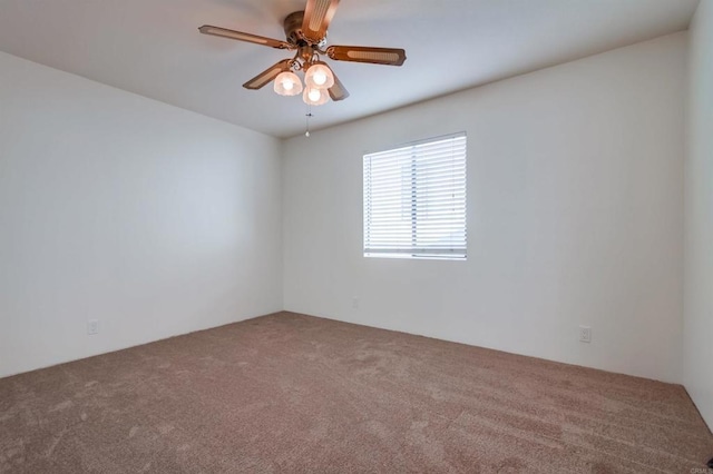 spare room featuring ceiling fan and carpet