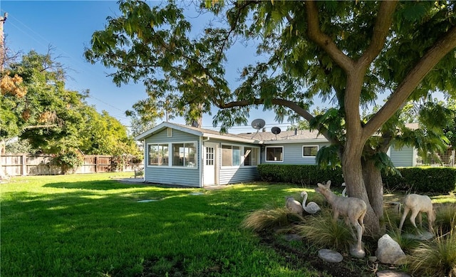 back of house with a lawn