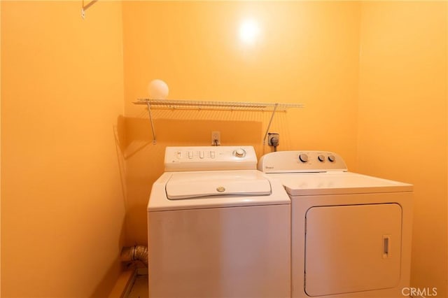 clothes washing area with separate washer and dryer