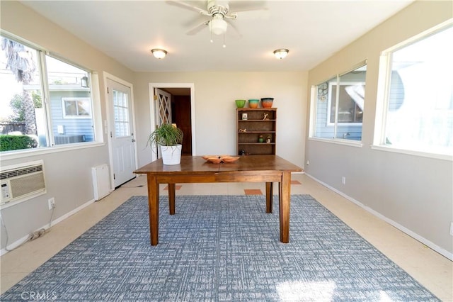 home office featuring ceiling fan, radiator heating unit, a wealth of natural light, and a wall mounted AC