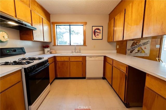 kitchen featuring sink, white appliances, a textured ceiling, and range hood