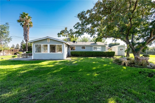 view of front of home featuring a shed, a front lawn, and a patio area