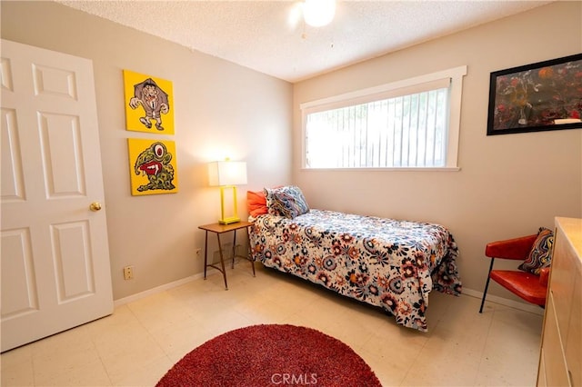 bedroom with a textured ceiling and ceiling fan