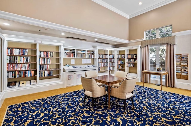 dining area featuring a high ceiling and ornamental molding