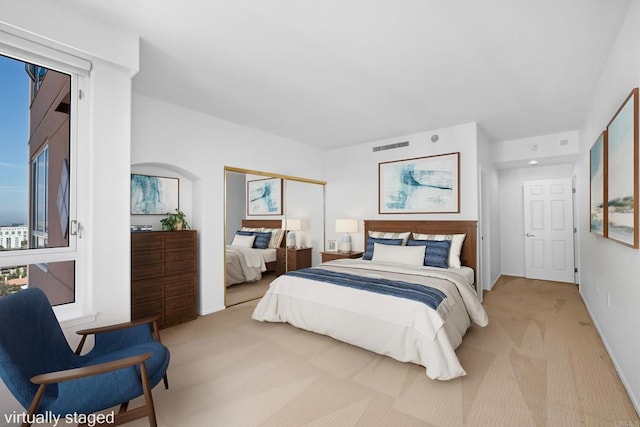 bedroom featuring light colored carpet