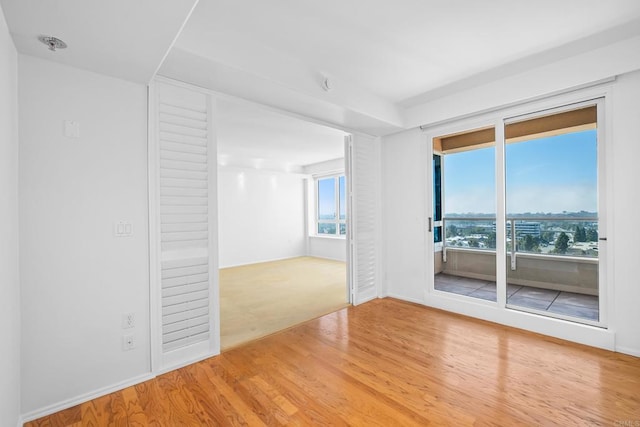 spare room with hardwood / wood-style floors