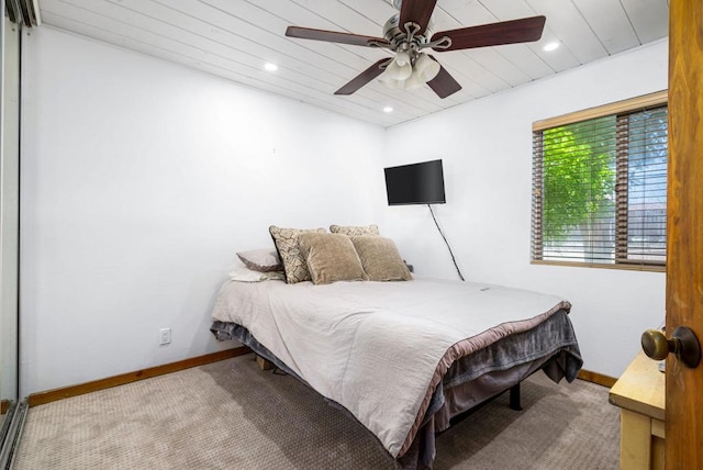 carpeted bedroom with ceiling fan and wood ceiling