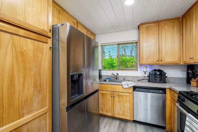 kitchen featuring stainless steel appliances, light hardwood / wood-style flooring, wood ceiling, and sink