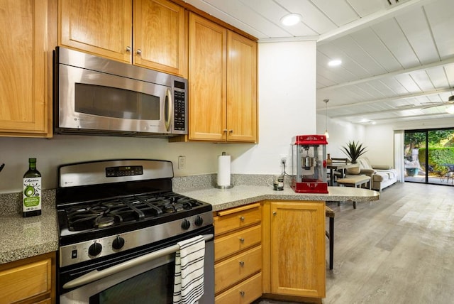 kitchen featuring ceiling fan, light hardwood / wood-style flooring, kitchen peninsula, wood ceiling, and appliances with stainless steel finishes