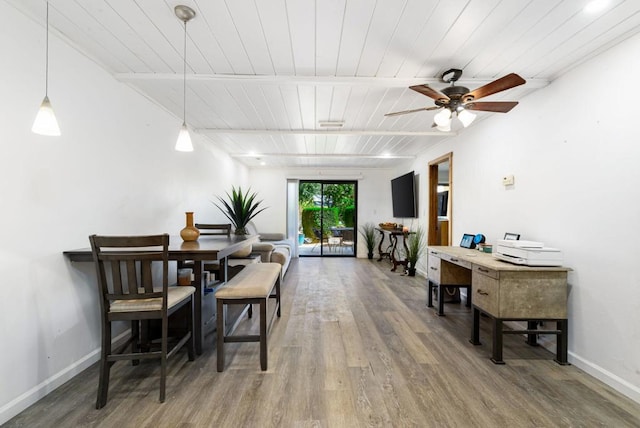 dining room featuring ceiling fan, wood-type flooring, and wooden ceiling