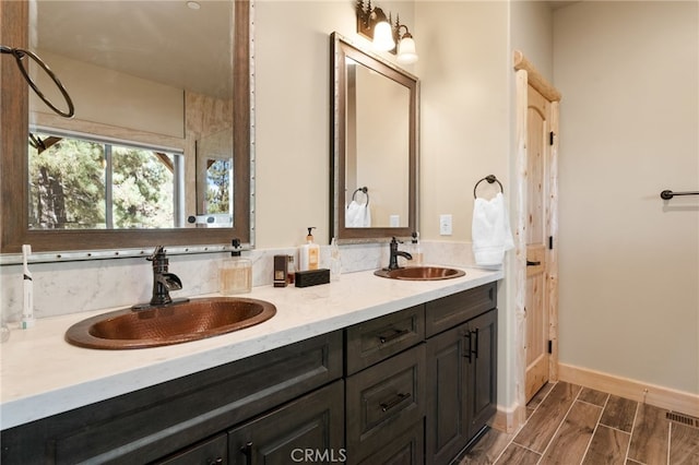 bathroom with hardwood / wood-style floors and vanity