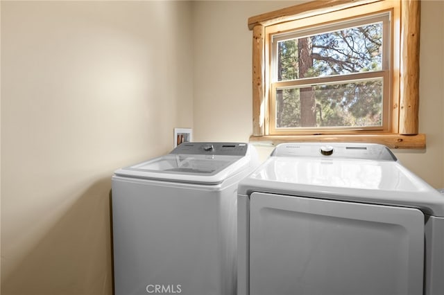 clothes washing area with washer and dryer and laundry area