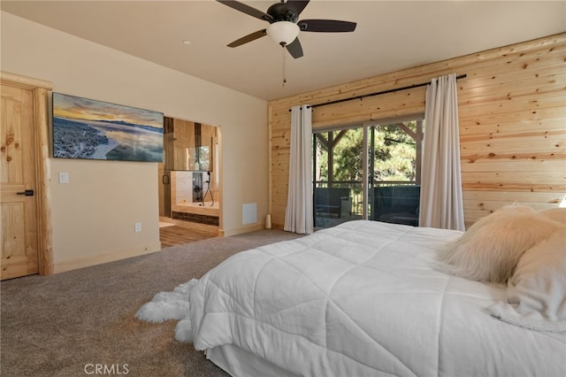 bedroom featuring carpet floors, wood walls, access to outside, and ceiling fan