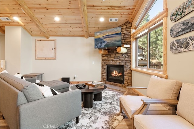 living room featuring lofted ceiling with beams, light hardwood / wood-style floors, a fireplace, and wood ceiling