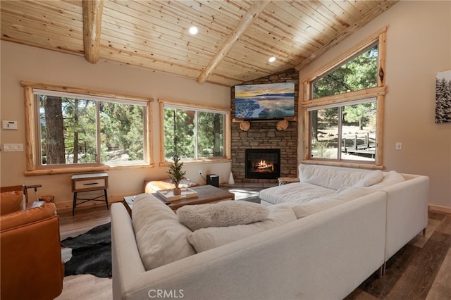 living room featuring vaulted ceiling with beams, wooden ceiling, hardwood / wood-style flooring, and a stone fireplace