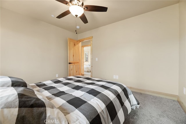 bedroom with ceiling fan, baseboards, and carpet