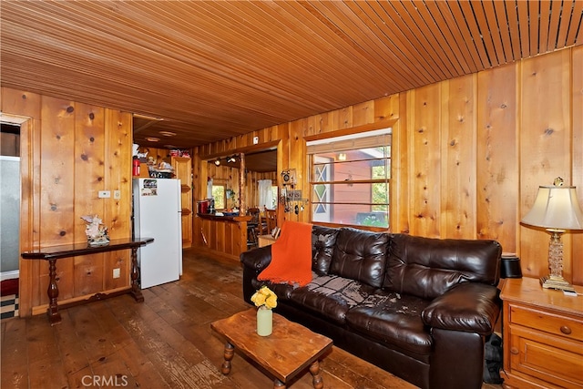 living room with wood walls, dark hardwood / wood-style floors, and wooden ceiling