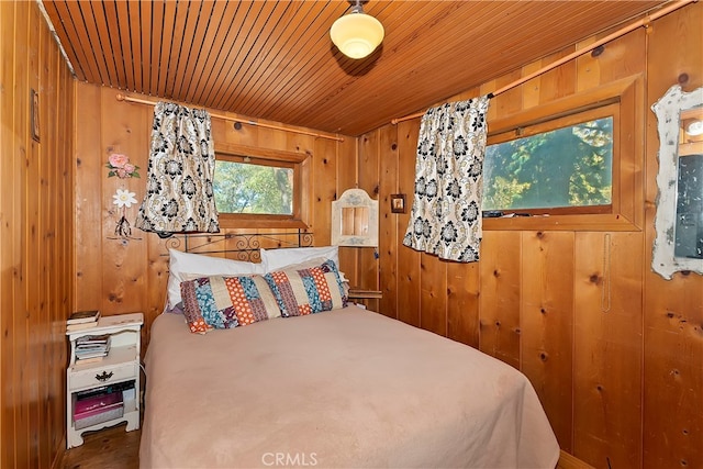 bedroom with wood walls and wooden ceiling