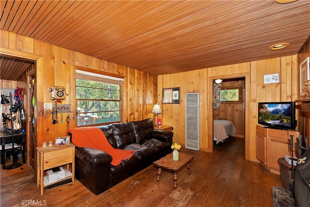 living room with hardwood / wood-style flooring, wood walls, and wooden ceiling