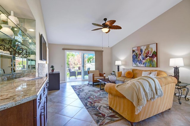 tiled living room featuring ceiling fan and high vaulted ceiling