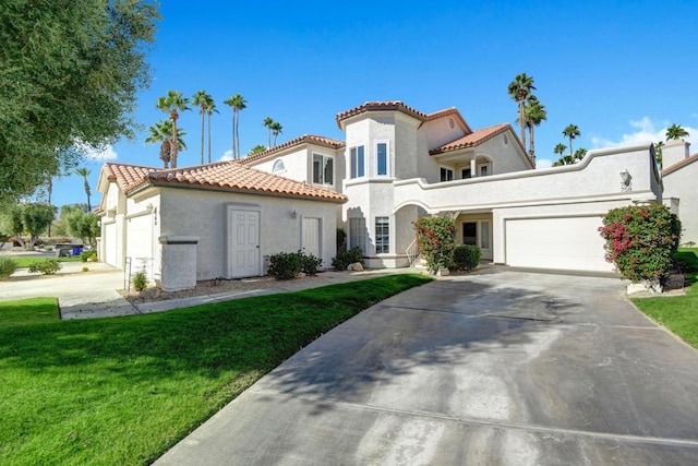 mediterranean / spanish house featuring a front lawn and a garage