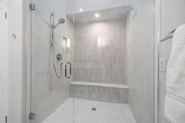 bathroom with a shower with door