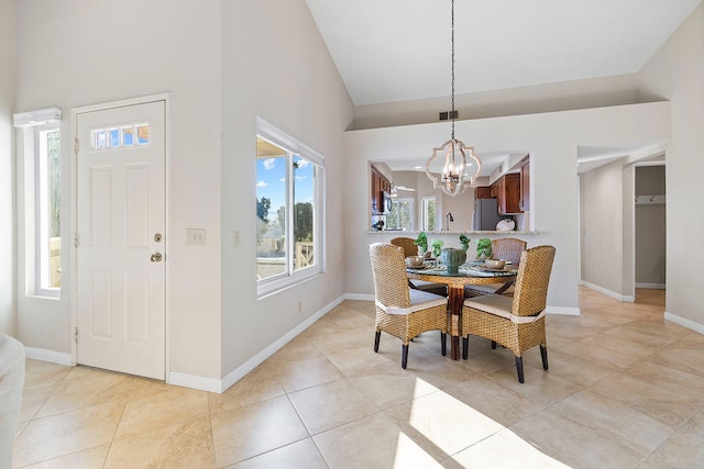 tiled dining area featuring high vaulted ceiling and a notable chandelier