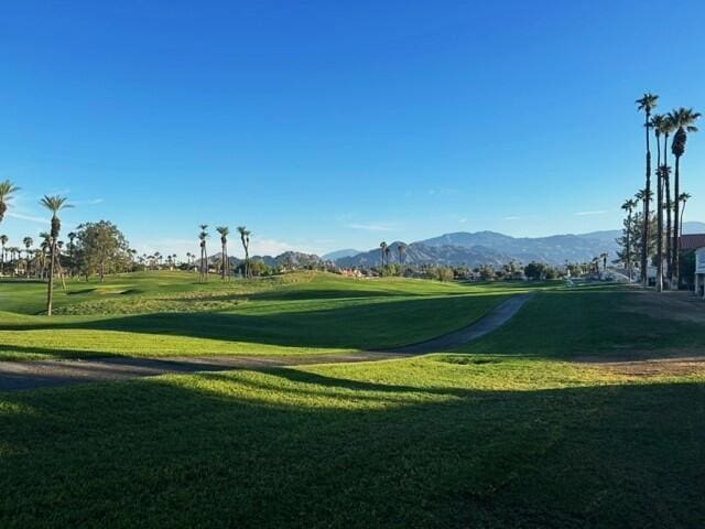 view of community with a mountain view and a yard