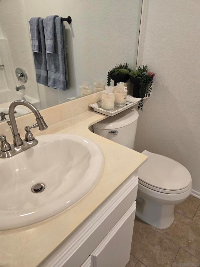 bathroom featuring tile patterned flooring, vanity, and toilet