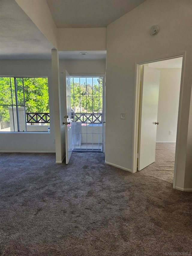 empty room with dark colored carpet