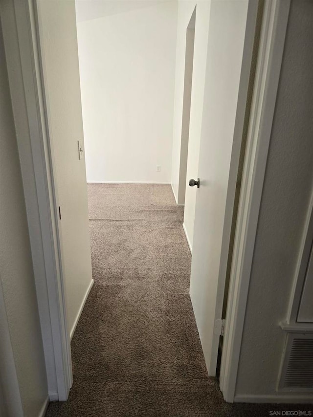 hallway with carpet floors