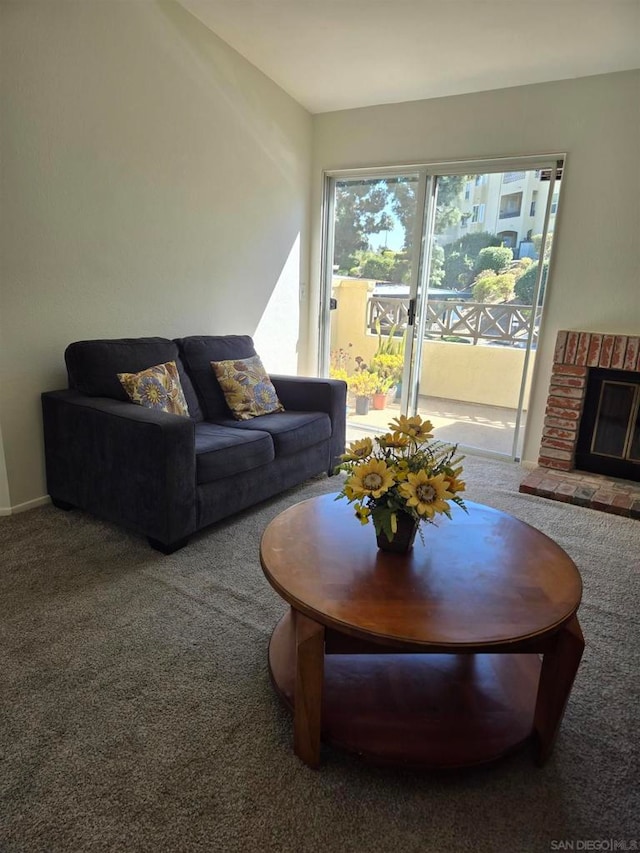 carpeted living room with a brick fireplace