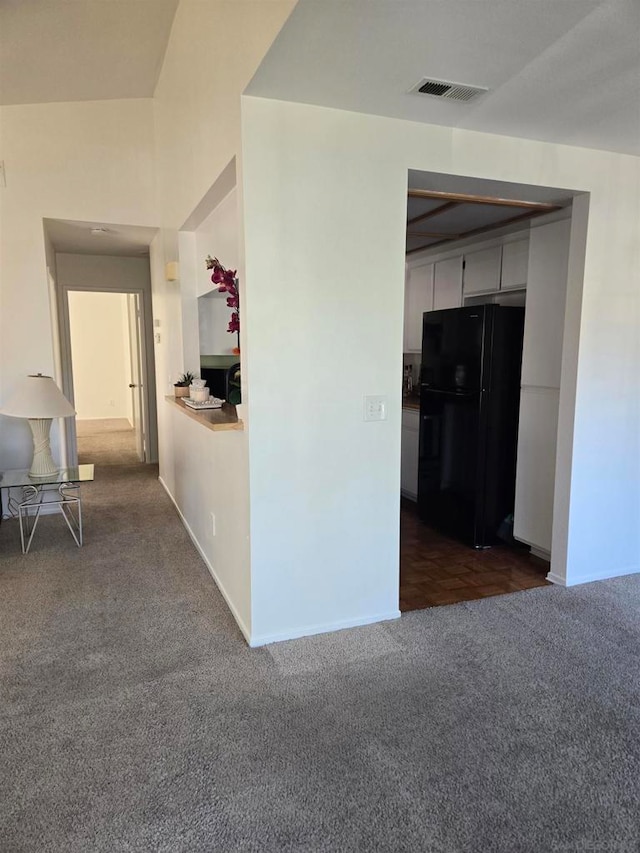 hallway featuring dark colored carpet