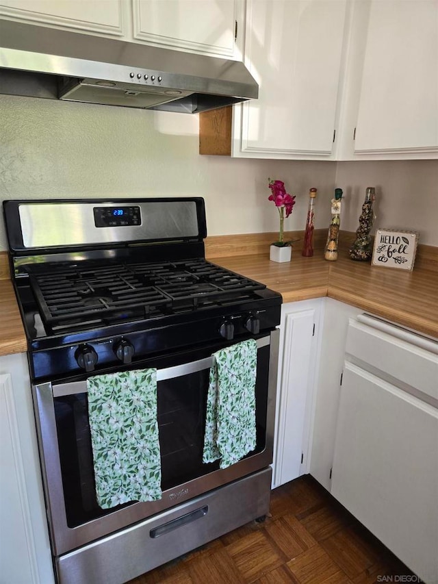 kitchen featuring wood counters, gas stove, white cabinetry, and dark parquet flooring