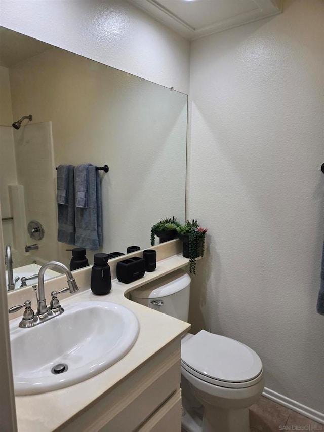 bathroom with tile patterned floors, vanity, and toilet