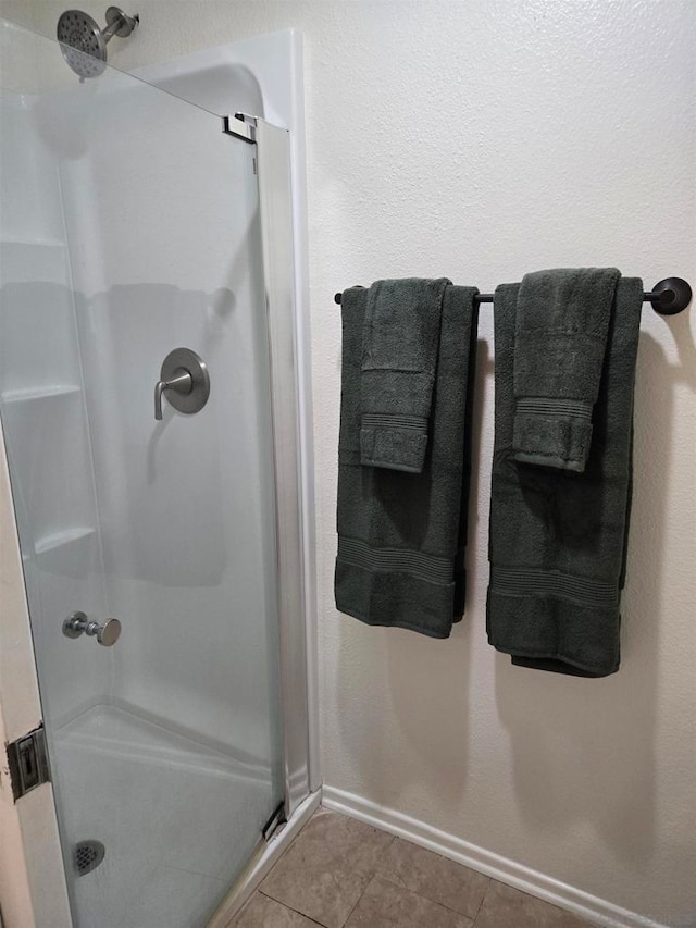 bathroom with tile patterned floors and walk in shower