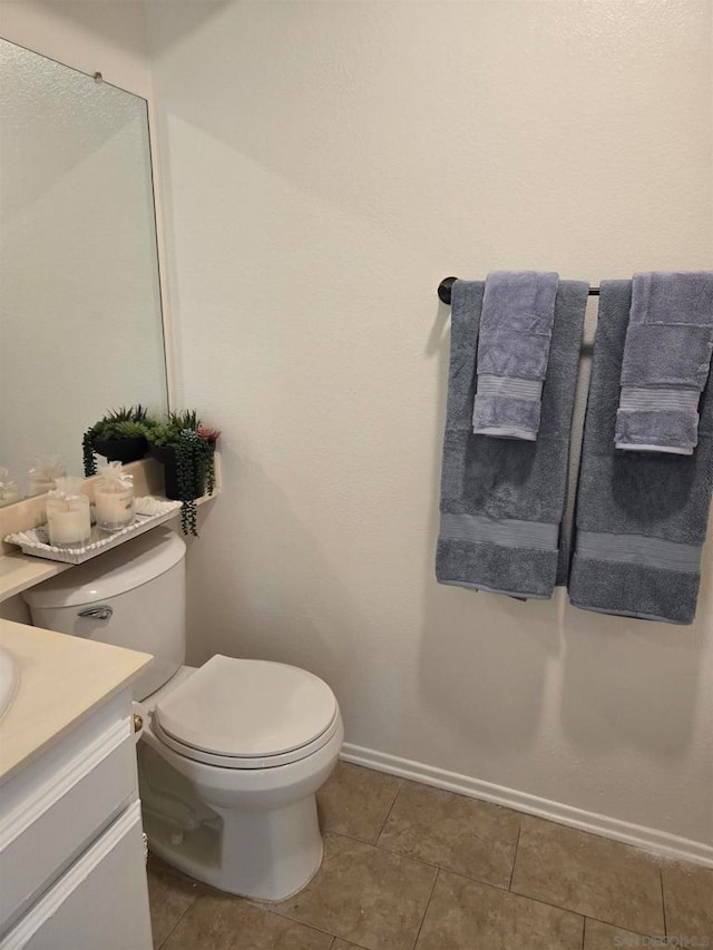 bathroom featuring toilet, tile patterned flooring, and vanity