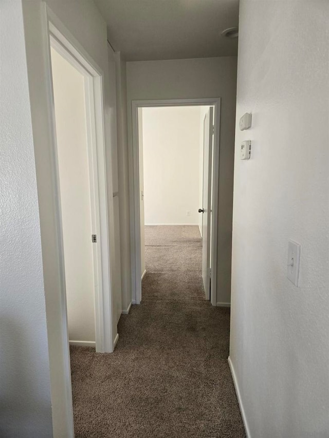 corridor with dark carpet